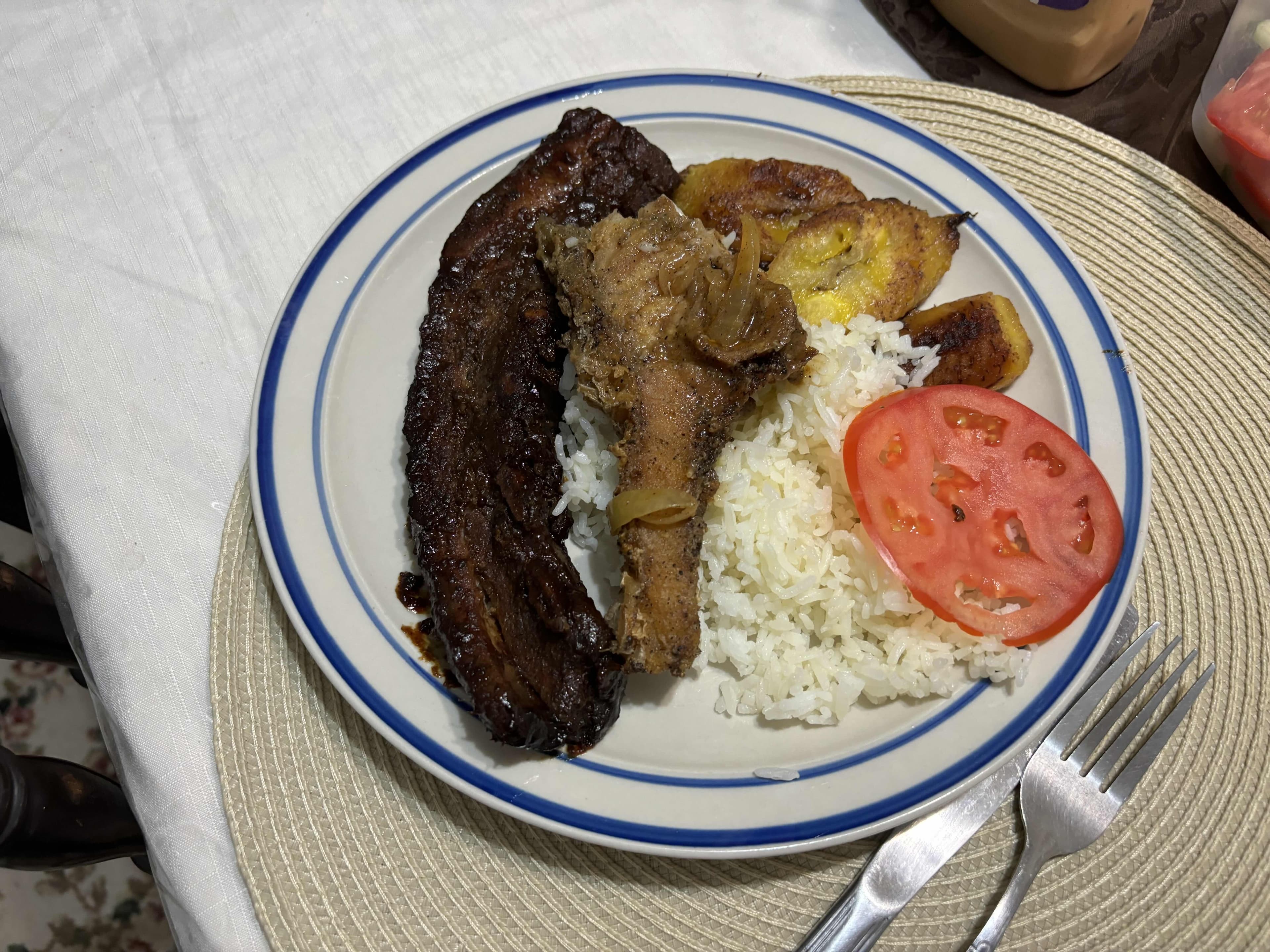 Fried fish, plantains, rice, and ribs
